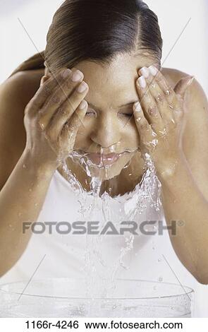 Stock Photograph - people, woman, beauty, brunette, indoors, facial, African-American. Fotosearch