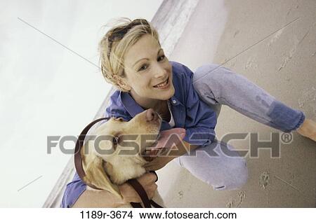 people, woman, dog, pet, beach, sunglasses, hugging View Large Photo Image Picture - people, woman, dog, pet, beach, sunglasses, hugging. Fotosearch