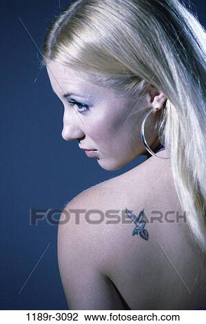 people, woman, earring, blond, tattoo, indoors, Caucasian View Large Photo Image Stock Image - people, woman, earring, blond, tattoo, indoors, Caucasian. Fotosearch