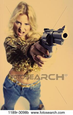 Stock Image - people, woman, gun, pointing, confrontation, violence, risk. Fotosearch