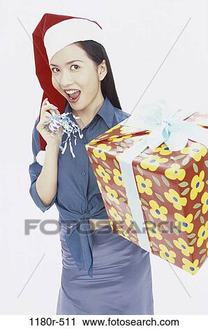 Stock Image - people, woman, hat, Asian, Christmas, gift, present. Fotosearch