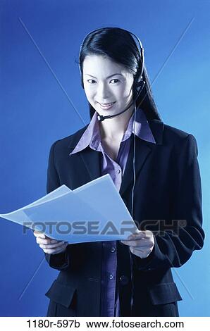 people, woman, headset, talking, Asian, papers, holding View Large Photo Image Stock Image - people, woman, headset, talking, Asian, papers, holding. Fotosearch