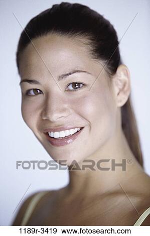 Stock Photo - people, woman, Hispanic, brunette, indoors, headshot, young adult. Fotosearch