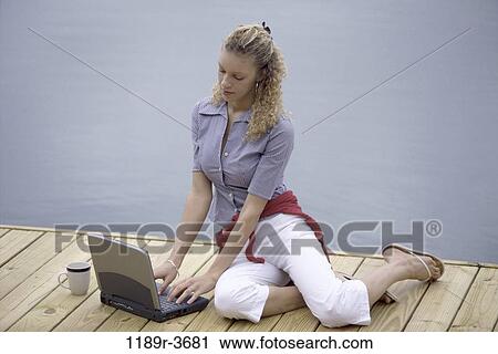 people, woman, laptop, outdoors, dock, blond, Caucasian View Large Photo Image Stock Image - people, woman, laptop, outdoors, dock, blond, Caucasian. Fotosearch