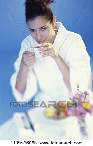 Stock Image - people, woman, morning, coffee, Hispanic, breakfast, drinking. Fotosearch