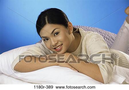 people, woman, sleeping, Asian, bed, laying, indoors View Large Photo Image Stock Photo - people, woman, sleeping, Asian, bed, laying, indoors. Fotosearch