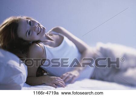 people, woman, smiling, bed, smile, laying View Large Photo Image Stock Image - people, woman, smiling, bed, smile, laying. Fotosearch