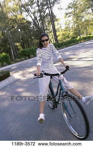 people, woman, sunglasses, outdoors, cycling, brunette, recreation View Large Photo Image Stock Image - people, woman, sunglasses, outdoors, cycling, brunette, recreation. Fotosearch