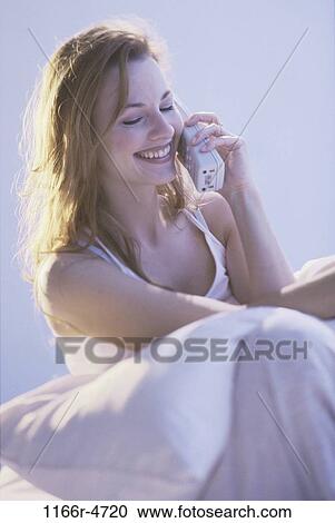 Stock Image - people, woman, telephone, talking, phone, cordless, indoors. Fotosearch