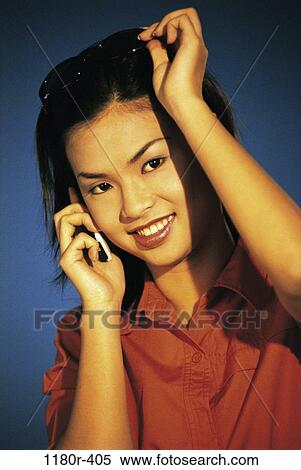 Stock Photography - people, woman, telephone, talking, Asian, phone, sunglasses. Fotosearch