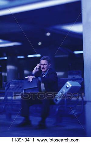 Stock Image - planner, briefcase, talking, phone, business, Middle-aged. Fotosearch