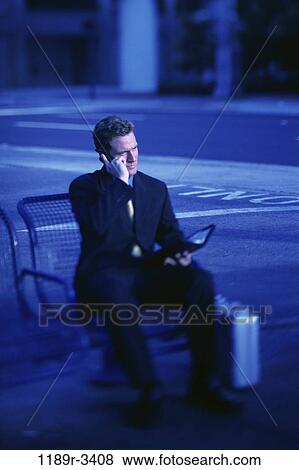 Stock Photo - planner, briefcase, talking, sitting, phone, street, business. Fotosearch