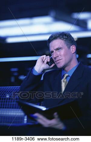 Stock Photograph - planner, talking, phone, business, Middle-aged, waiting. Fotosearch