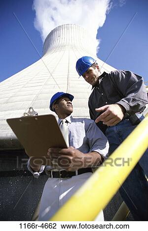 Stock Image - plant, multiethnic, men, industry, clipboard, outdoors, industrial. Fotosearch