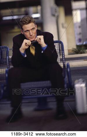 Stock Image - reflection, blur, briefcase, suit, sitting, business. Fotosearch