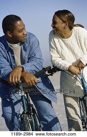Picture - relaxed, people, couple, bicycle, outdoors, Middle-aged, leisure. Fotosearch