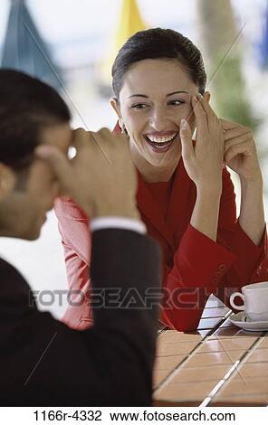 Stock Image - relaxed, relaxation, smiling, coffee, Hispanic, laughing, cafe. Fotosearch