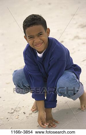 sand, people, beach, sweater, boy, child, mischievous View Large Photo Image Picture - sand, people, beach, sweater, boy, child, mischievous. Fotosearch