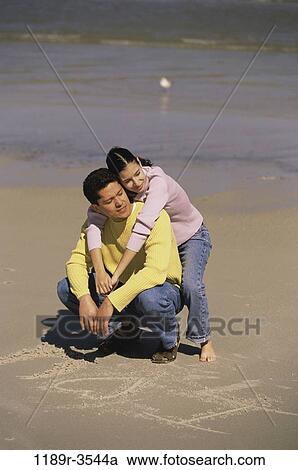 sand, people, couple, sitting, beach, writing, jeans View Large Photo Image Stock Image - sand, people, couple, sitting, beach, writing, jeans. Fotosearch