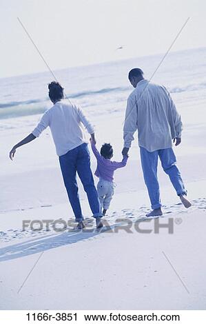 Stock Image - sand, people, hands, walking, beach, holding, lifting. Fotosearch