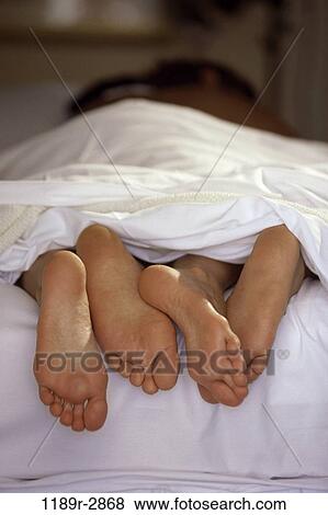 sleeping, couple, bed, body parts, feet, indoors, Caucasian View Large Photo Image Stock Photo - sleeping, couple, bed, body parts, feet, indoors, Caucasian. Fotosearch