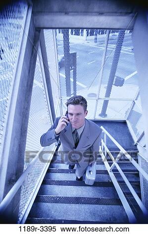 Stock Photography - stairs, climbing, briefcase, talking, phone, street. Fotosearch
