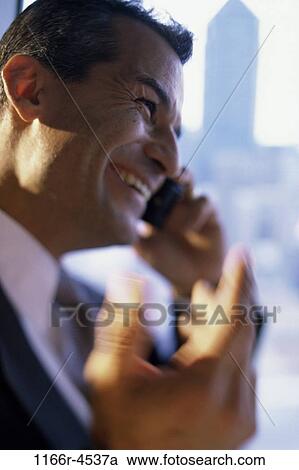 Stock Image - talking, Hispanic, business, Middle-aged, cell phone, businessman. Fotosearch