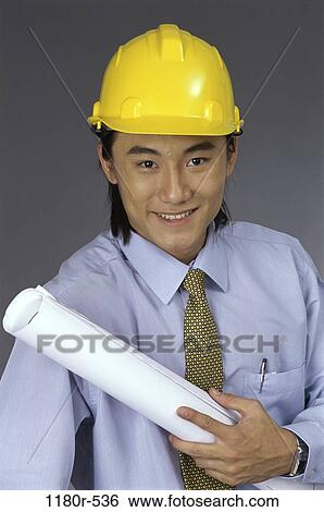 Stock Photograph - tie, industry, construction, Asian, worker, plans. Fotosearch