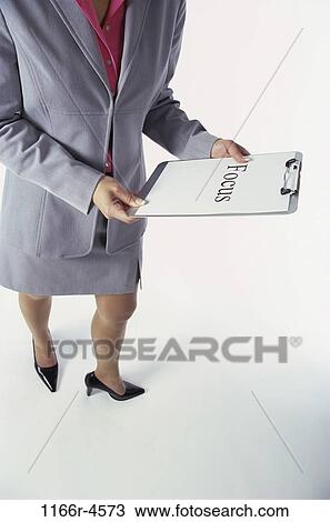 Stock Image - woman, clipboard, business, commitment, message, focus, indoors. Fotosearch