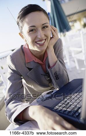 Stock Image - woman, computer, laptop, business, outdoors, Caucasian, businesswoman. Fotosearch