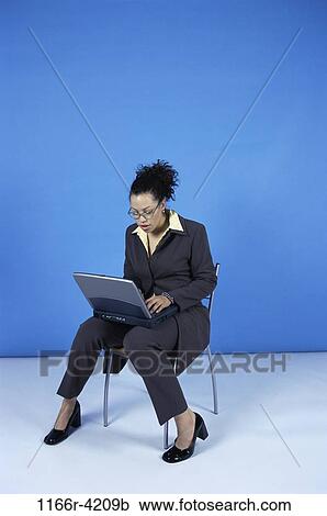 Stock Image - woman, eyeglasses, computer, laptop, business, using, indoors. Fotosearch