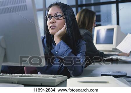 woman, eyeglasses, computer, concentrating, business, serious, using View Large Photo Image Picture - woman, eyeglasses, computer, concentrating, business, serious, using. Fotosearch