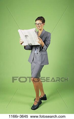 Stock Photography - woman, newspaper, eyeglasses, reading, business, indoors, Caucasian. Fotosearch