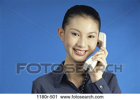 Stock Image - woman, telephone, talking, Asian, phone, business, talk. Fotosearch