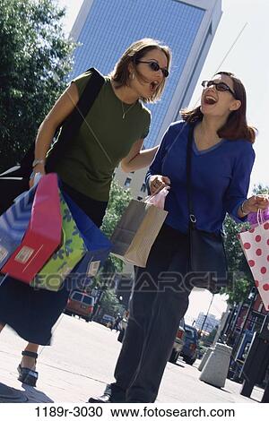 women, people, laughing, sunglasses, outdoors, carrying, shopping View Large Photo Image Stock Image - women, people, laughing, sunglasses, outdoors, carrying, shopping. Fotosearch