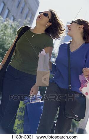 women, people, sunglasses, outdoors, carrying, shopping, friends View Large Photo Image Stock Image - women, people, sunglasses, outdoors, carrying, shopping, friends. Fotosearch