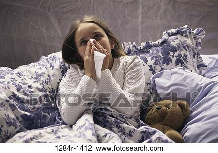 Stock Image - bed, stuffed animal, girl, cold, tissue, health. Fotosearch