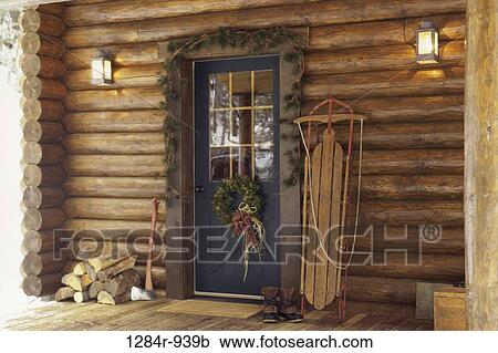 Stock Image - Christmas, outdoors, decorations, wreath, still life, ax. Fotosearch