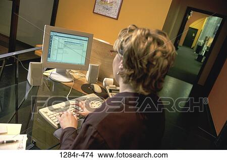Picture - desk, woman, computer, business, office, indoors. Fotosearch