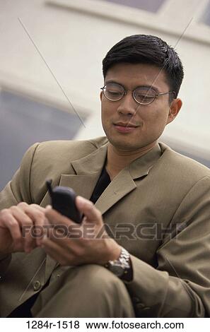 dial, dialing, telephone, Asian, eyeglasses, phone, business View Large Photo Image Stock Photo - dial, dialing, telephone, Asian, eyeglasses, phone, business. Fotosearch