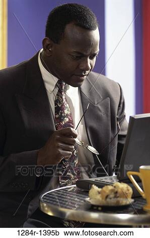 Stock Image - eyeglasses, concentration, computer, reading, laptop, concentrating. Fotosearch