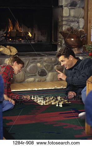 fire, people, chess, floor, fireplace, games, family View Large Photo Image Stock Photo - fire, people, chess, floor, fireplace, games, family. Fotosearch