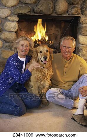 fire, people, dog, couple, sitting, senior, floor View Large Photo Image Stock Photograph - fire, people, dog, couple, sitting, senior, floor. Fotosearch