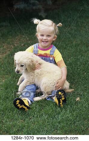 Stock Image - grass, people, dog, puppy, pet, girl, outdoors. Fotosearch