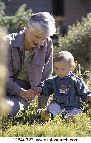 grass, people, sitting, outdoors, family, yard, grandson View Large Photo Image Stock Image - grass, people, sitting, outdoors, family, yard, grandson. Fotosearch