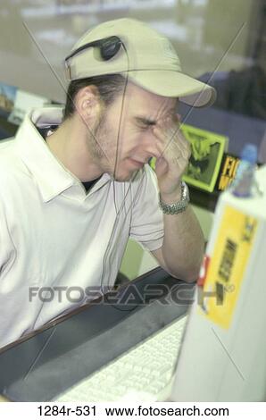 Stock Image - headache, desk, computer, stress, motion, business. Fotosearch