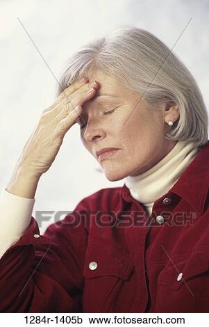 Stock Image - headache, woman, senior, patient, health, touching, pain. Fotosearch