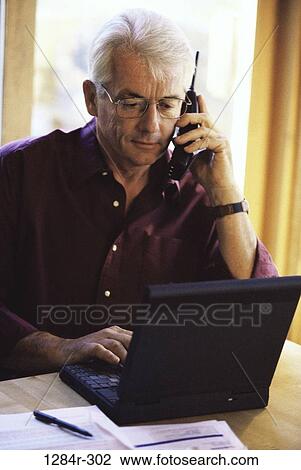 Stock Image - home, telephone, talking, senior, computer, laptop. Fotosearch
