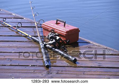 Stock Image - lake, sports, dock, fishing, sports equipment, still life, fishing poles. Fotosearch