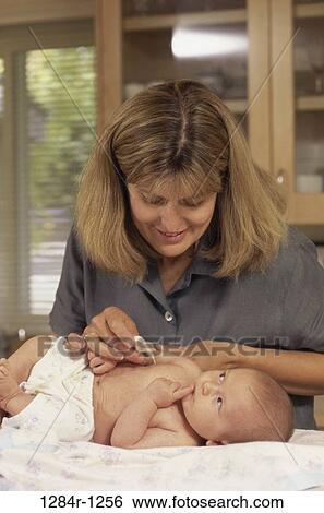 Stock Photograph - mother, baby, thermometer, health, temperature, child, checking. Fotosearch